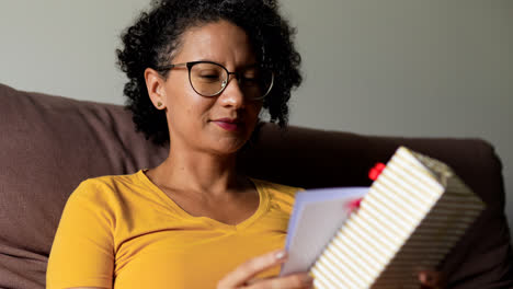 Woman-holding-card-and-gift-box